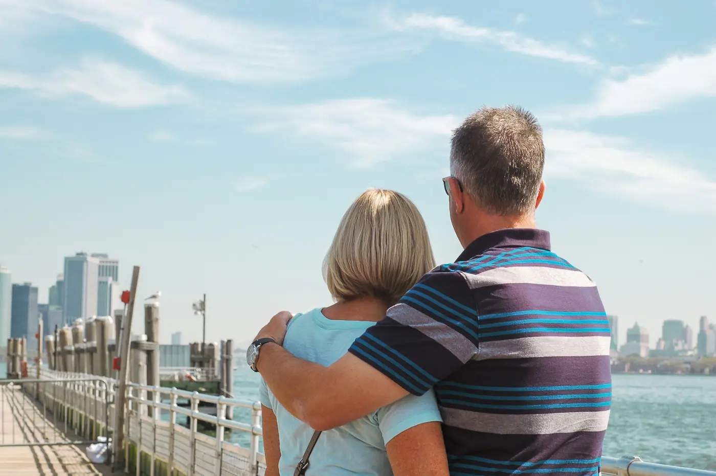 Couple looking across bridge toward city
