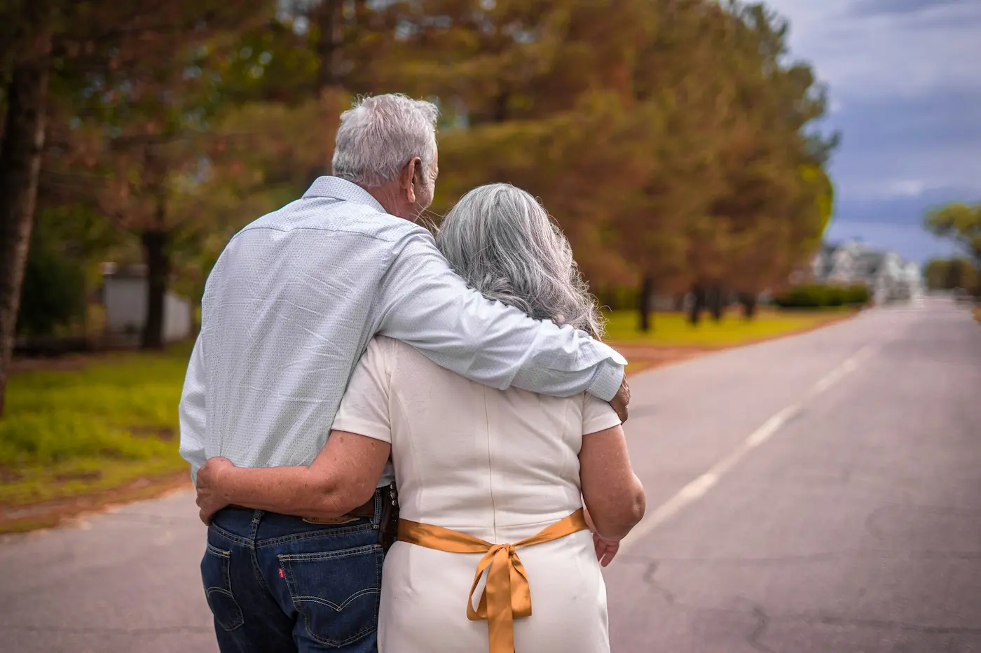 Older couple walking together down a peaceful street